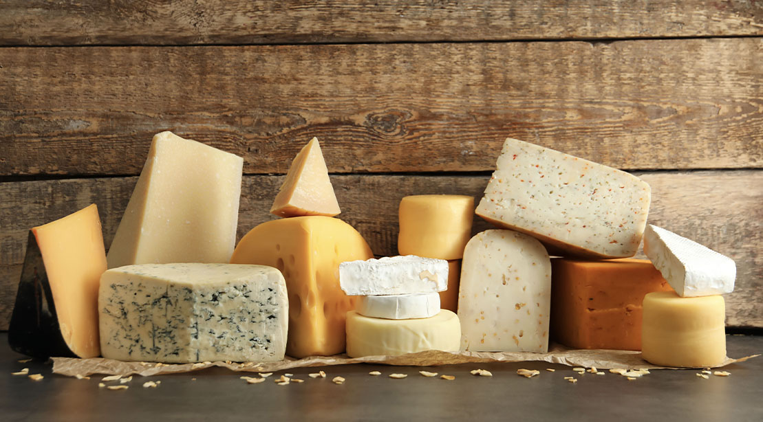 Various cheeses displayed on a board