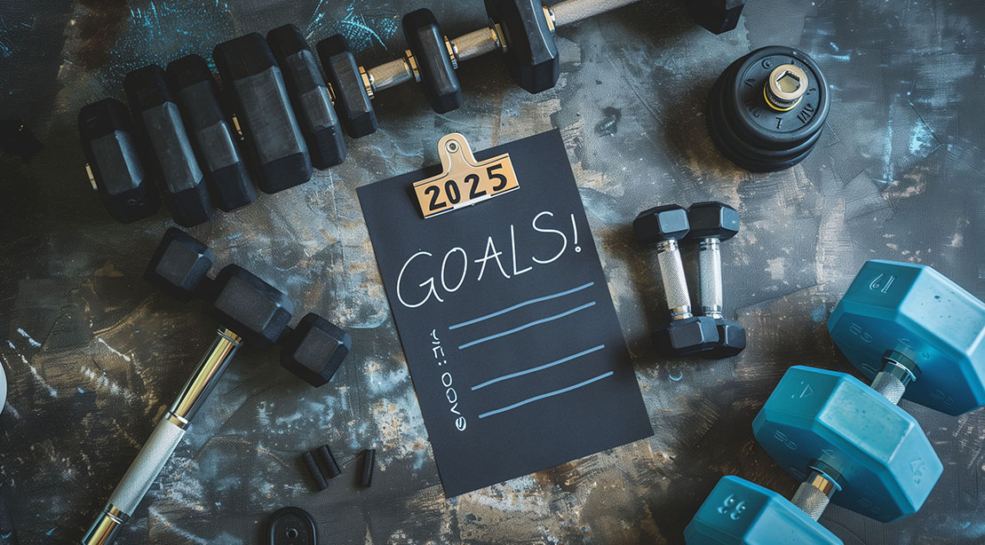 Weights and gym equipment used to reach and plan your fitness goals for 2025